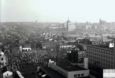 A photograph taken from the top of a building shows the historic skyline of the 15th Ward.